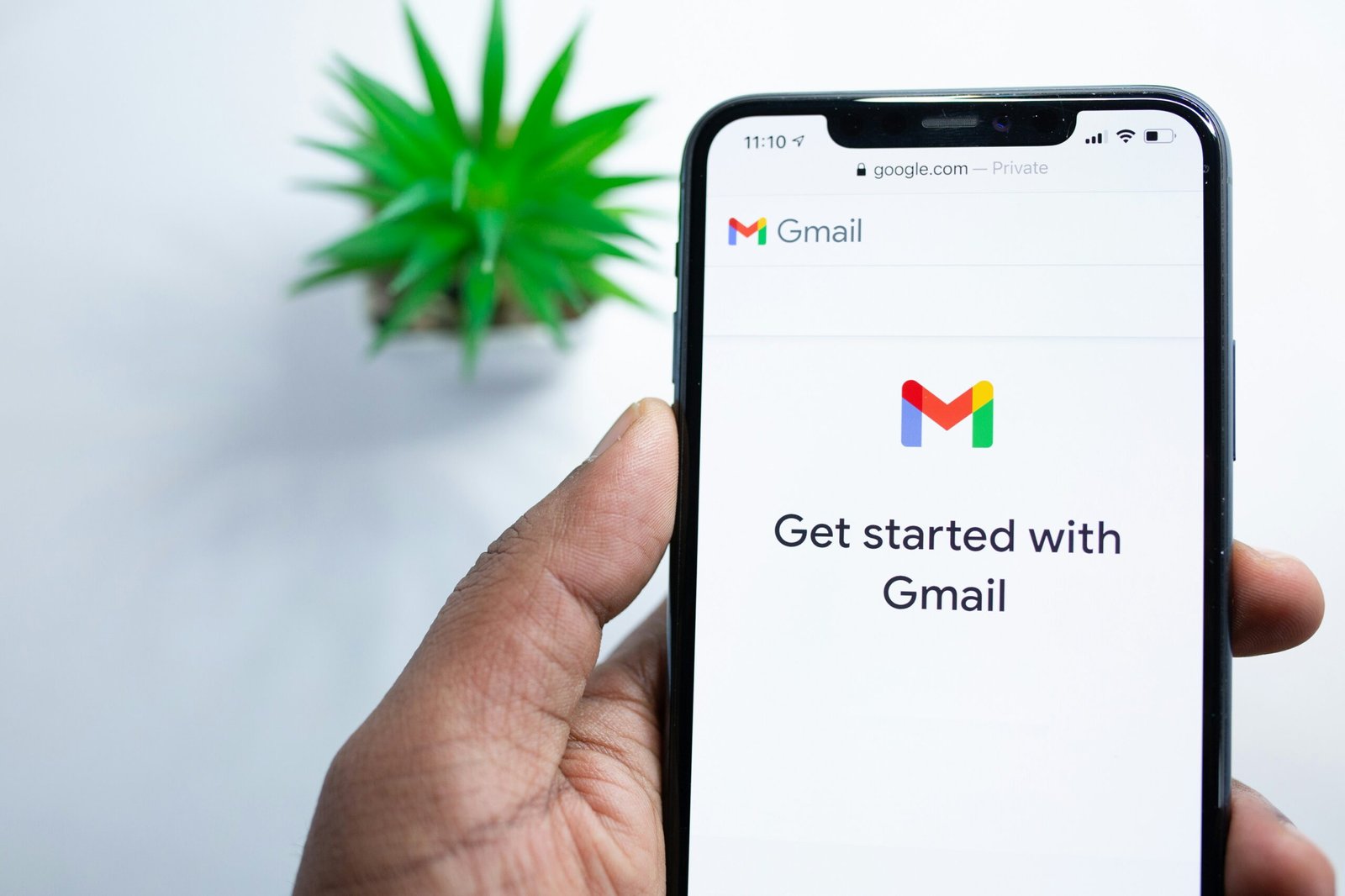 A person is opening Gmail on his phone